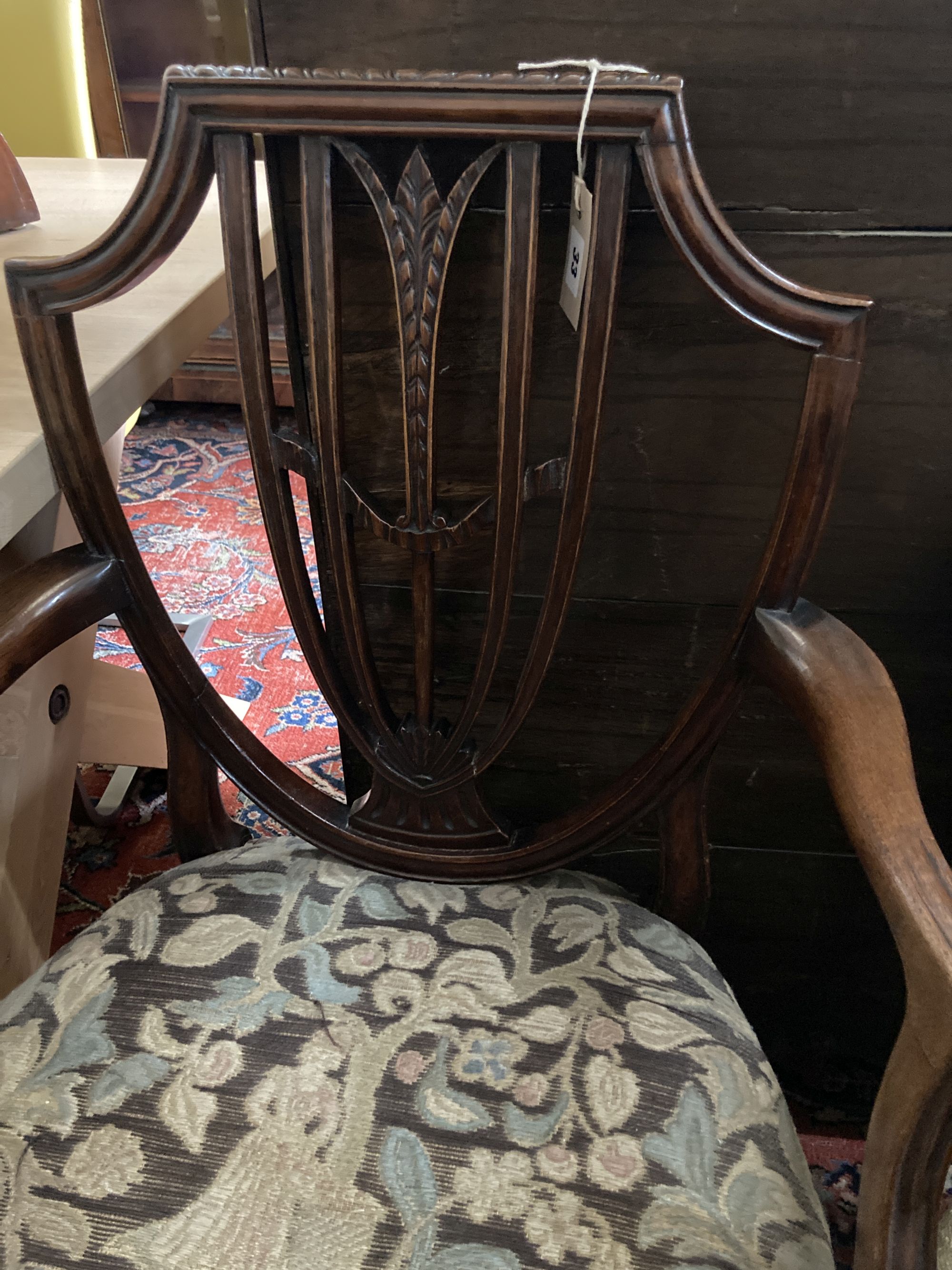 A Hepplewhite style mahogany armchair and a Louis XV walnut fauteuil covered in tapestry